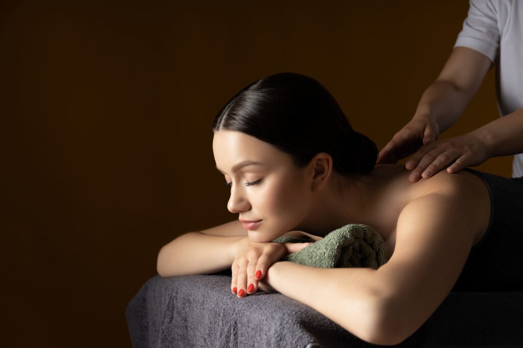 Therapist massaging a woman's shoulders on a massage table at HealthCure Massage Botany